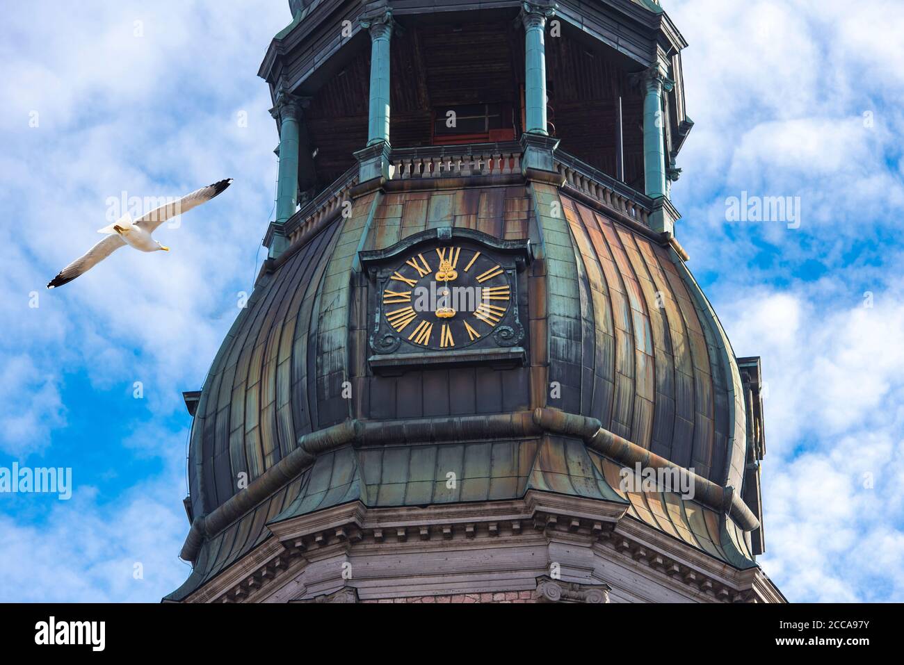 Close-up of spire with clock of St. Peter’s Church, old town in Riga, Latvia Stock Photo