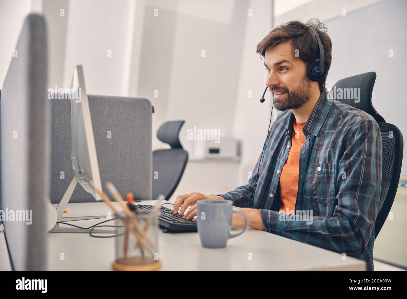Contact center worker young man hi-res stock photography and images - Alamy