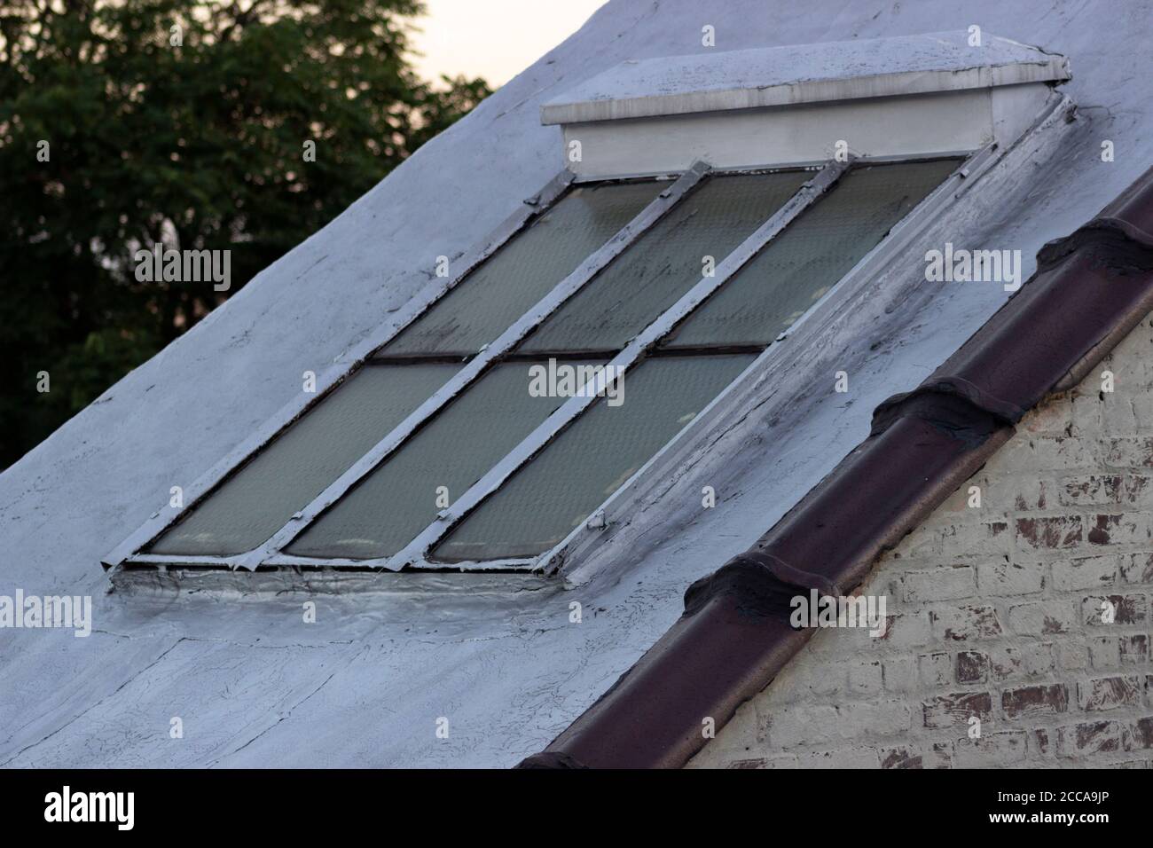 Staircase airshaft exterior window, with painted brick wall Stock Photo