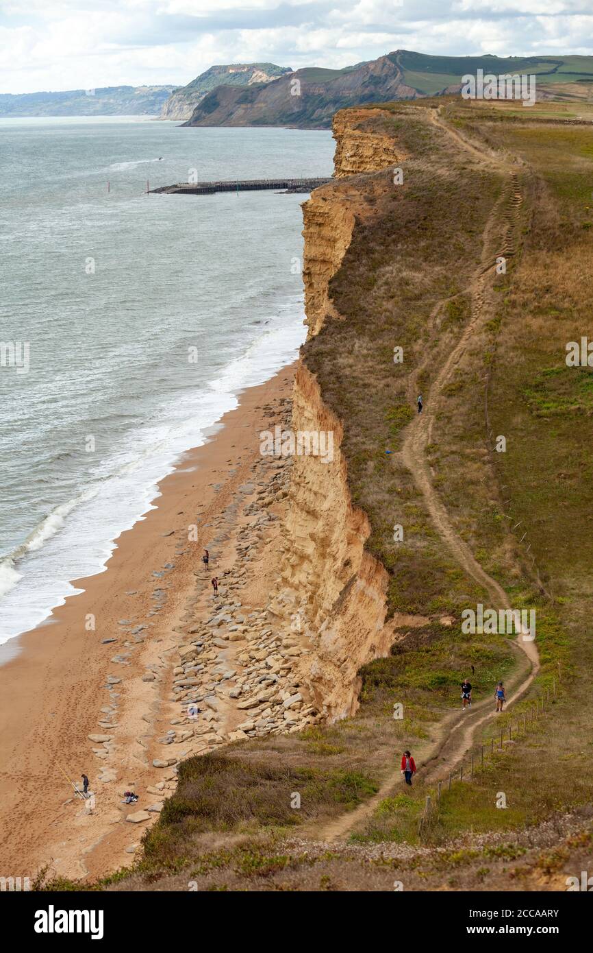 walkers near Burton Freshwater bay along the South West Coast Path, on the Jurassic Coast, Dorset, England, UK Stock Photo