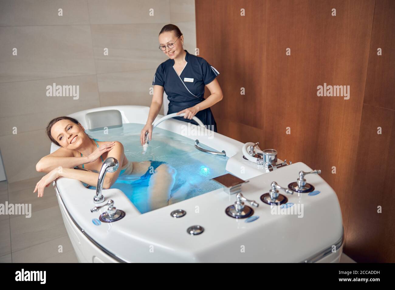 Joyful woman lying in a hydromassage bathtub Stock Photo Alamy