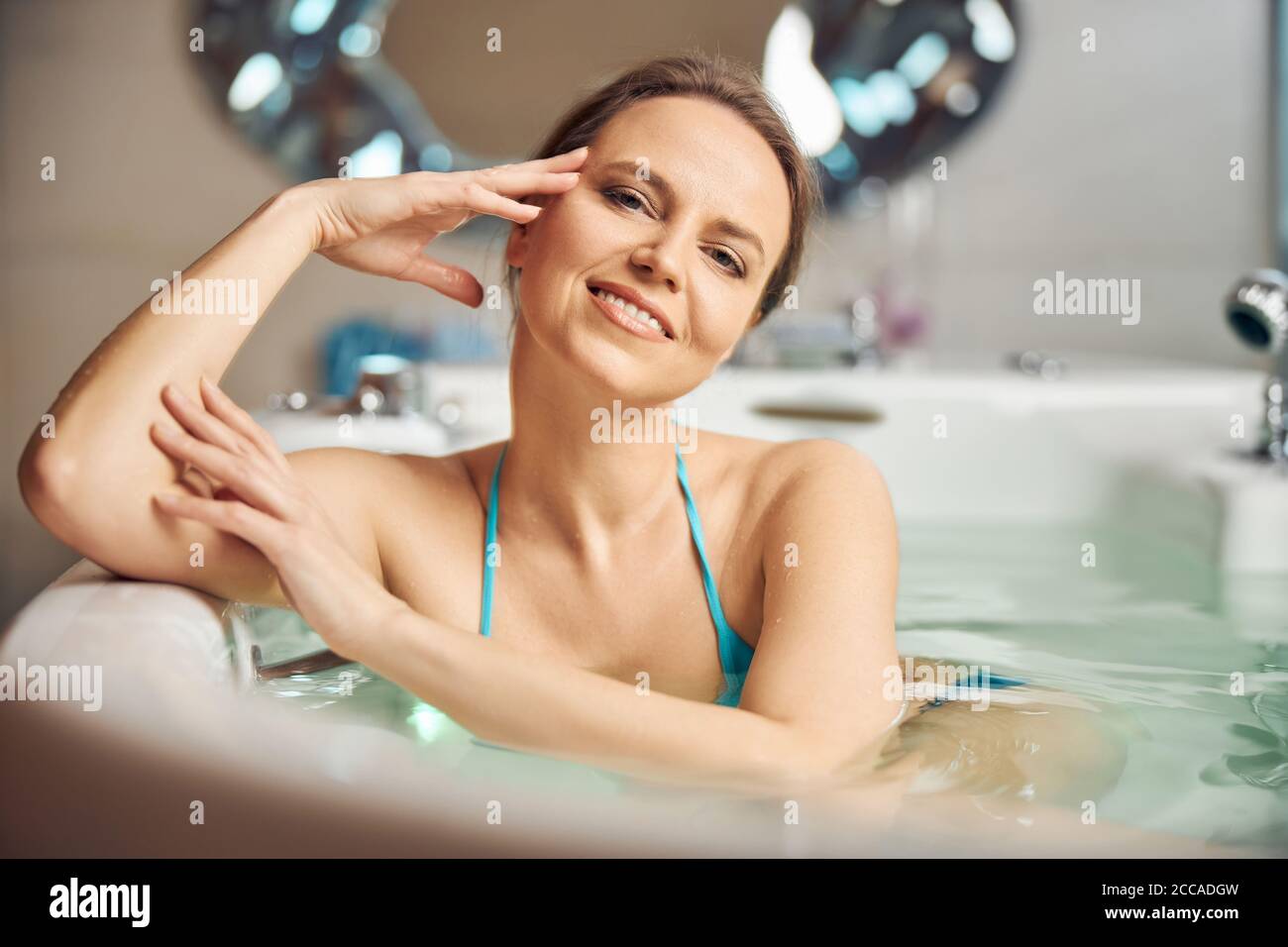 Beautiful woman relaxing in a hot bath Stock Photo