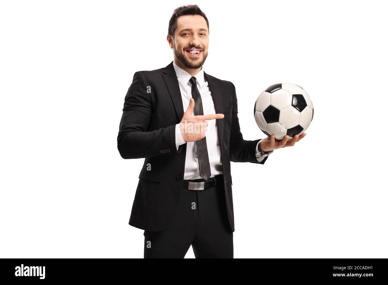 Professional man in a black suit holding a soccer ball and pointing ...