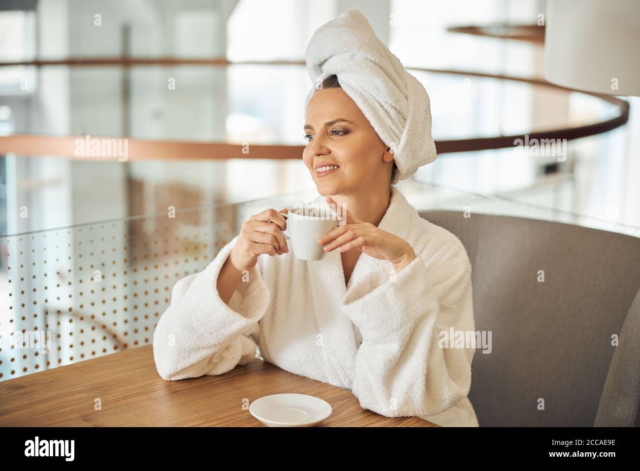 Cheerful pretty lady holding a tea cup Stock Photo