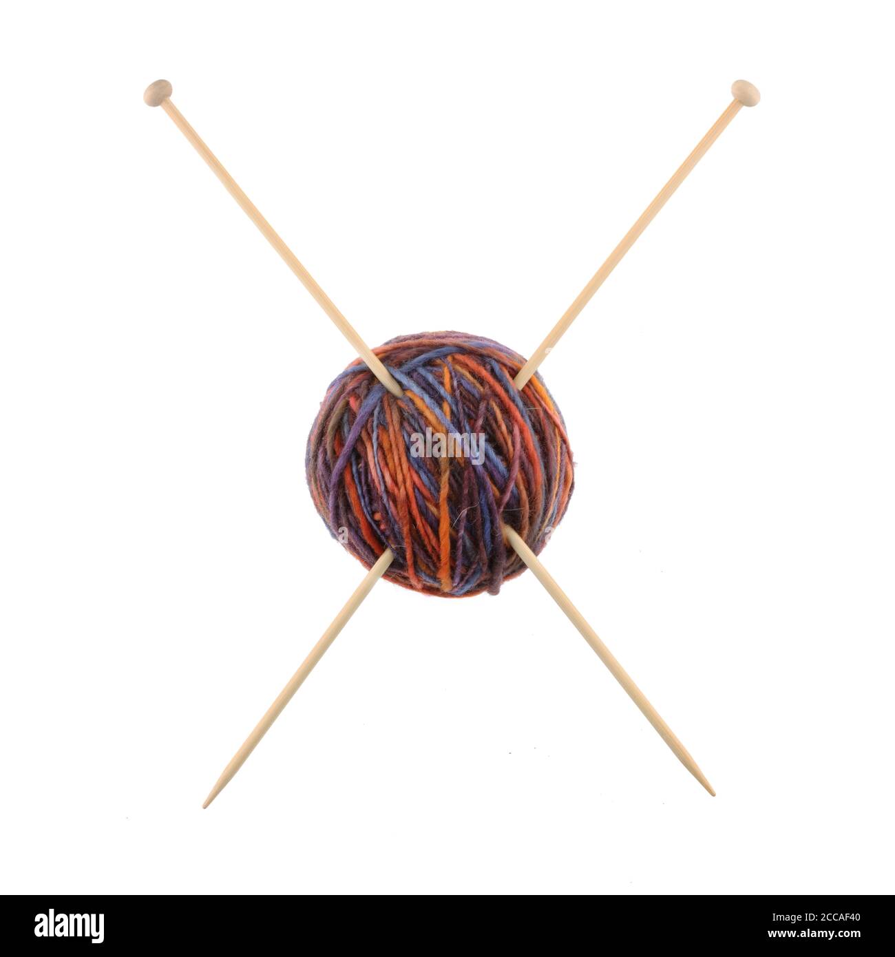Ball of wool and knitting needles making a cross Stock Photo