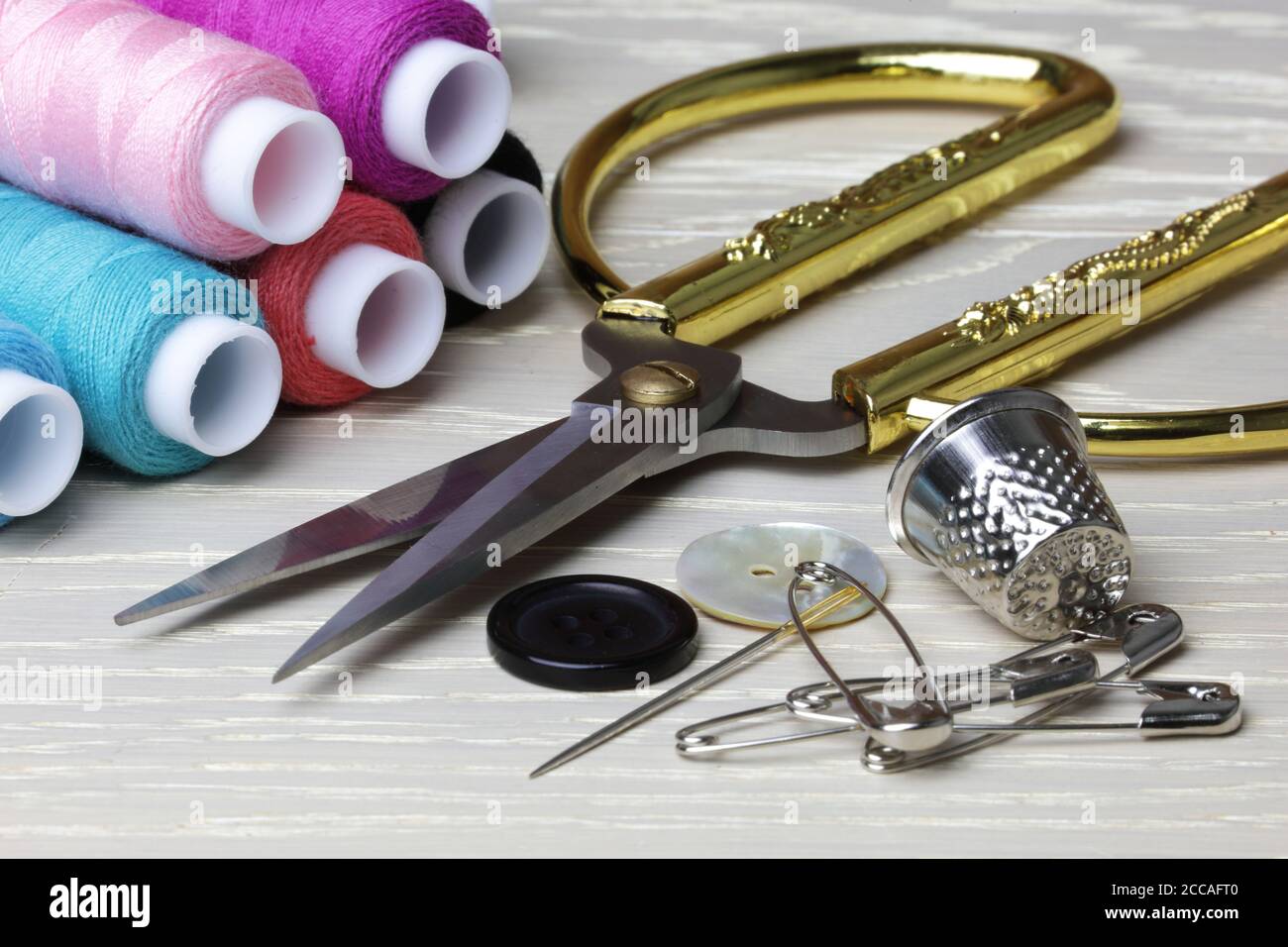 Scissors and sewing supplies thimble cotton pins Stock Photo