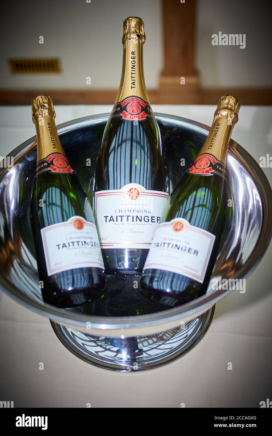Three unopened bottles of Taittinger champagne in a silver bucket at a wedding reception Stock Photo