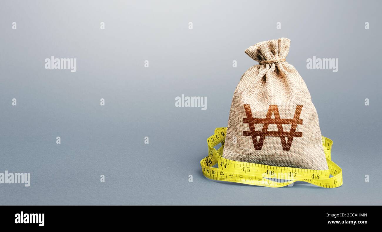 South korean won money bag and measuring tape meter. Analysis of economic situation. Formation and optimization of the budget, savings. Assessment of Stock Photo