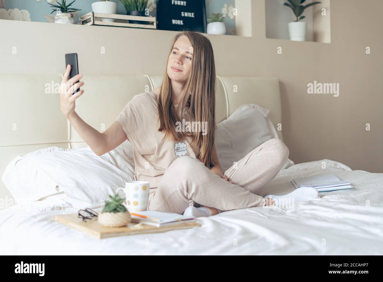 Happy, smiling, relaxed, and cheerful young woman taking a selfie on ...