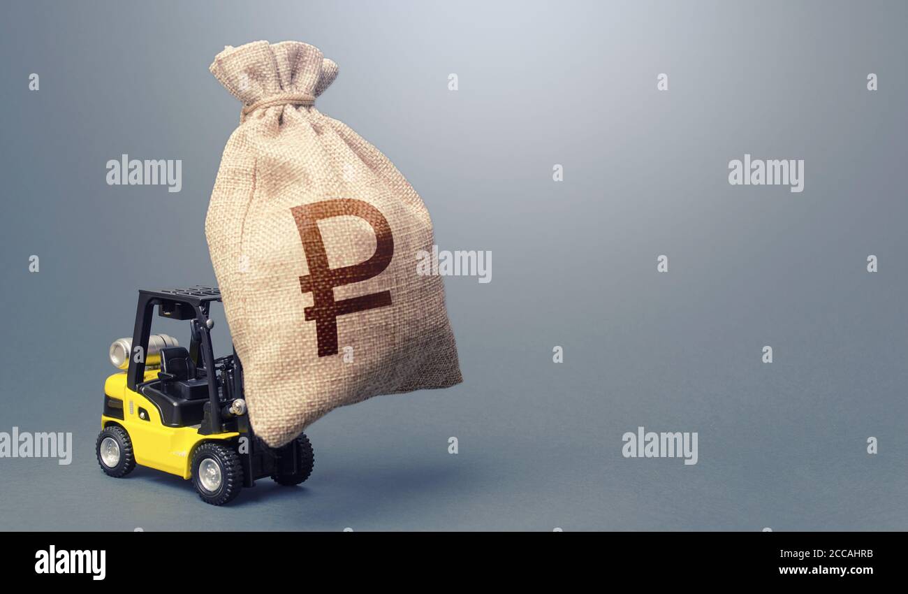Forklift carrying a russian ruble money bag. Strongest financial assistance, business support. Anti-crisis budget. Borrowing on capital market. Stimul Stock Photo