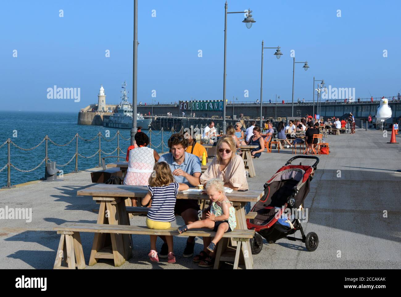 People relaxing late afternoon Folkestone Pier Kent England Stock Photo