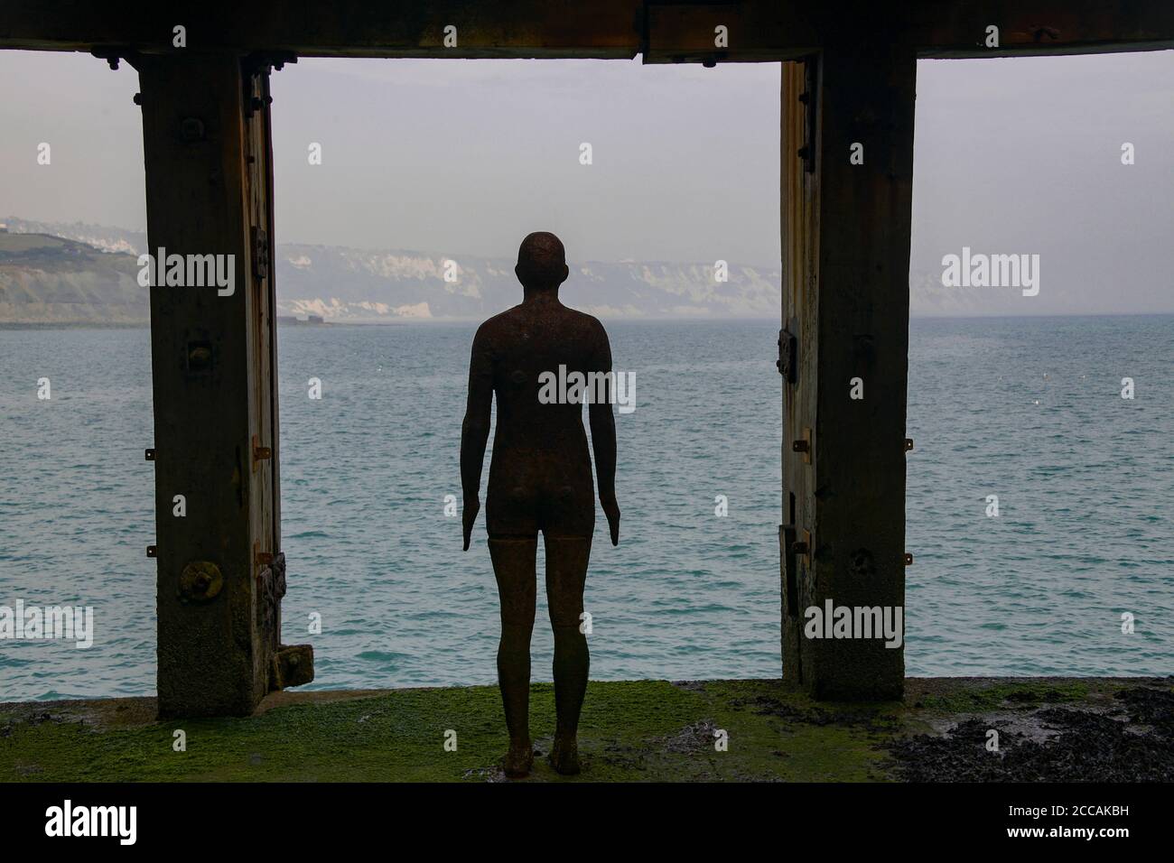 Silhouette Anthony Gormley steel statuue of a man Folkestone Kent England Stock Photo