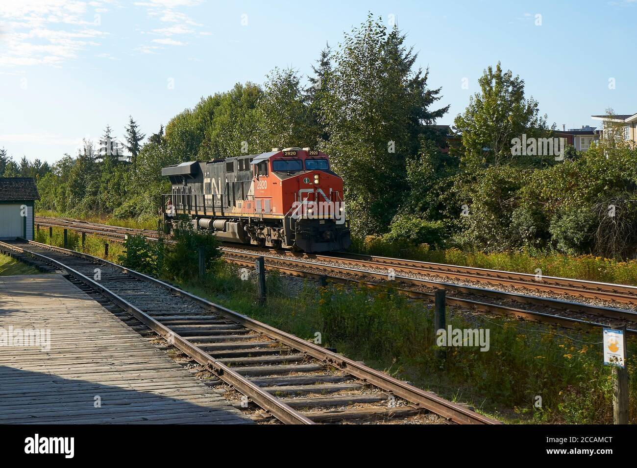 Canadian National Railway diesel locomotive number 2920 passing the CNR Heritage Railway Station,  Fort Langley, British Columbia, Canada Stock Photo