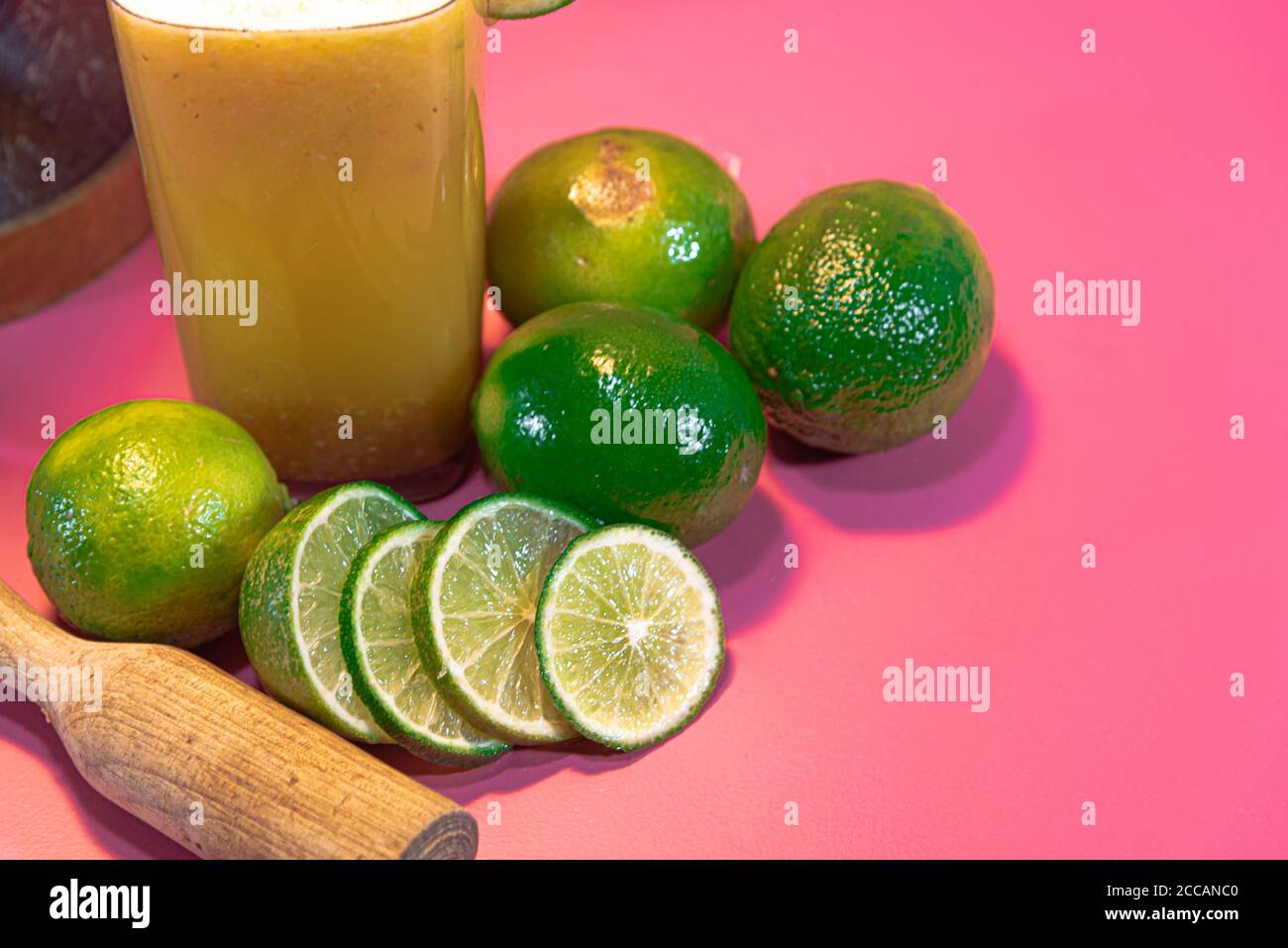Citrus aurantifolia. Lemon juice. Lemonade. Drink rich in vitamin C. Lemon in halves. Pink