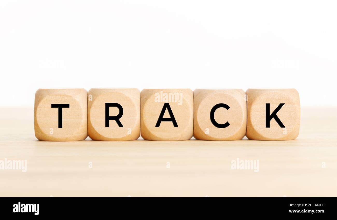 Track concept. Wooden block with text on wooden table. Copy space Stock Photo