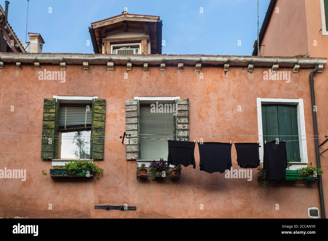 laundry hanging over a rope in a traditional italian european house - Venice Stock Photo