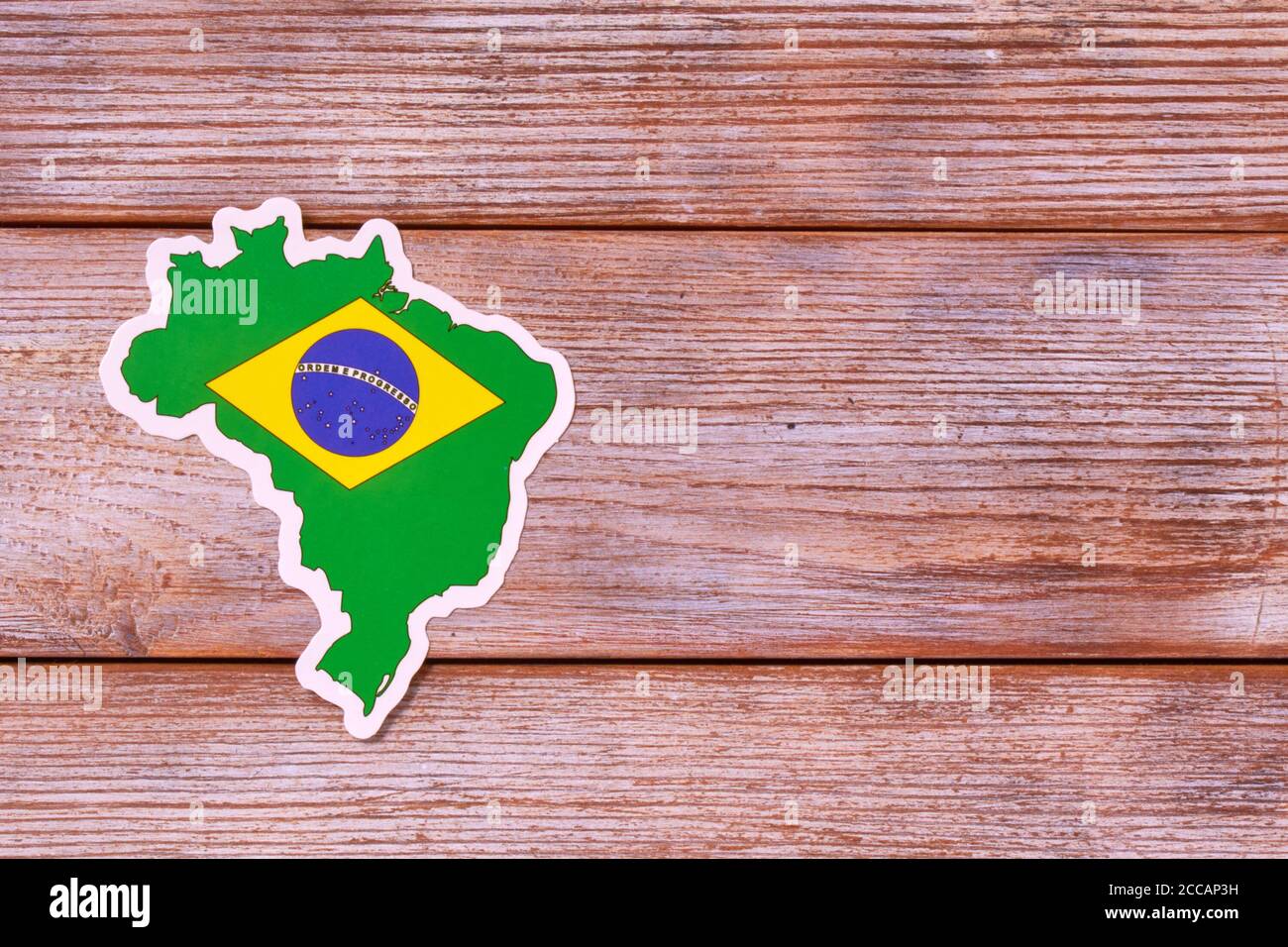Country border outline map of Brasil. Shape and national flag on white  wooden background. Copy Space for design Stock Photo - Alamy
