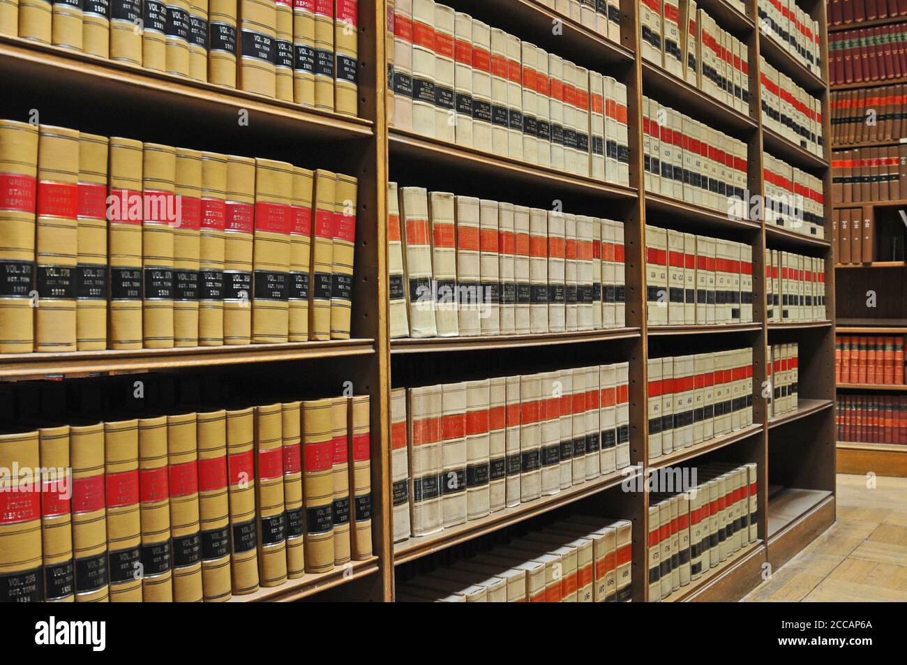 Shelves of organized law books in a library for students, academics and legal professionals to conduct research Stock Photo