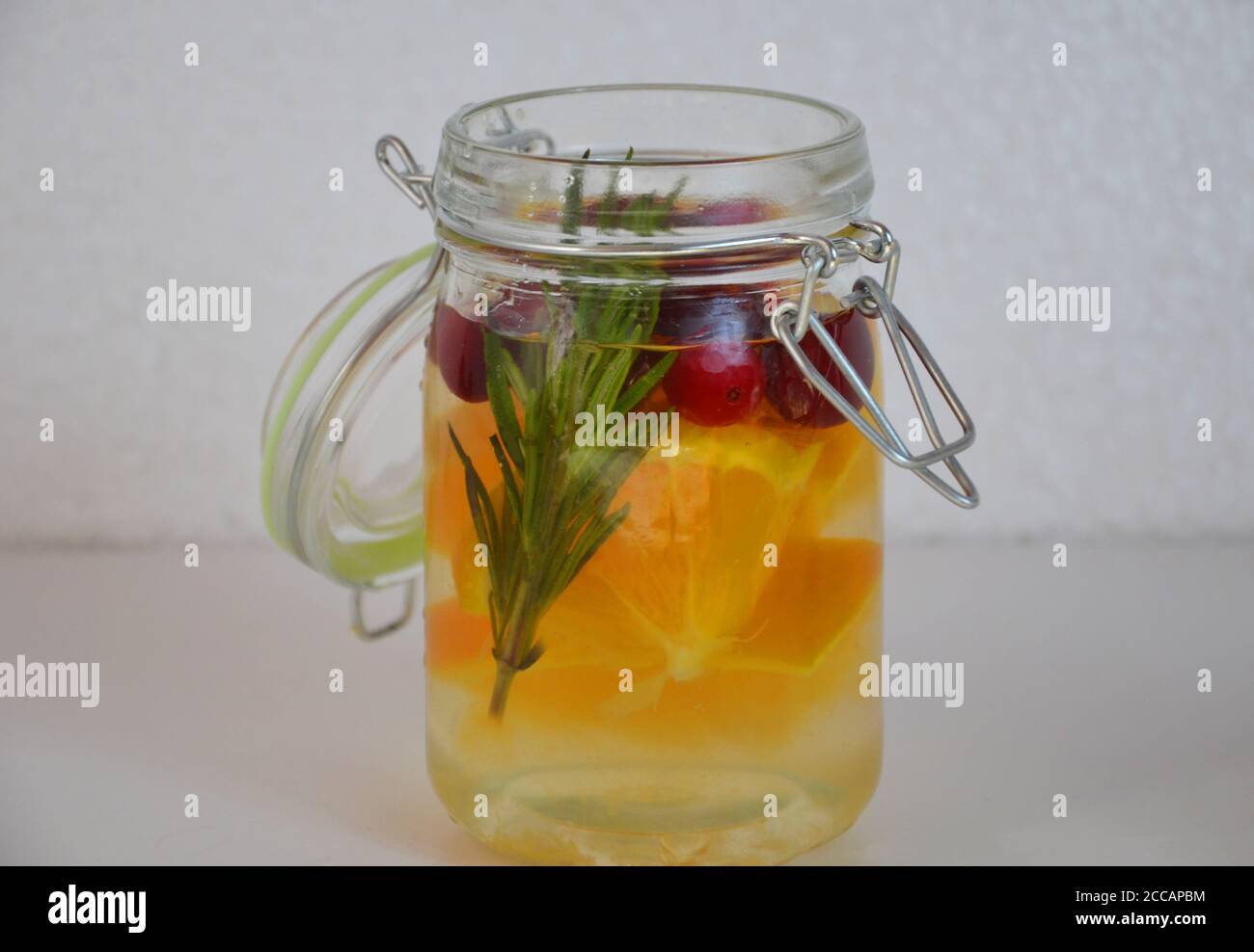 detox water with orange, cranberry and rosemary, healthy drink for the
