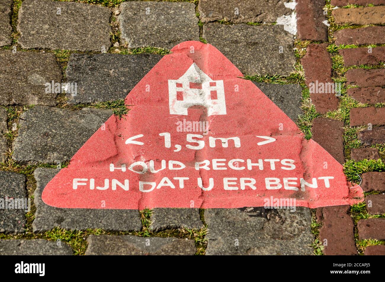 Elburg, The Netherlands, July 30, 2020: red pavement sticker with the 1,5 metre distance rule to prevent spreading of covid-19,as wel as 'keep right, Stock Photo