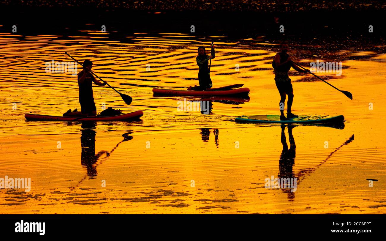 OGMORE BY SEA - WALES 20 AUG: People using Stand up Paddleboards on the river Ogmore at sunset, Ogmore by Sea, Wales on the 20th August 2020. Photo by Stock Photo