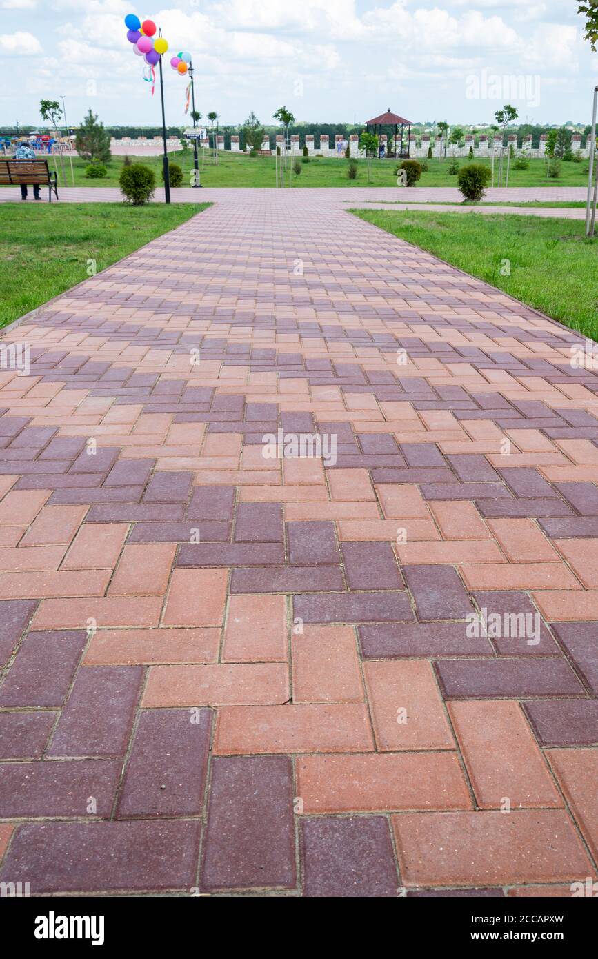 Moldova, Bender - May 18, 2019: Colored red paving slabs in the park of ...