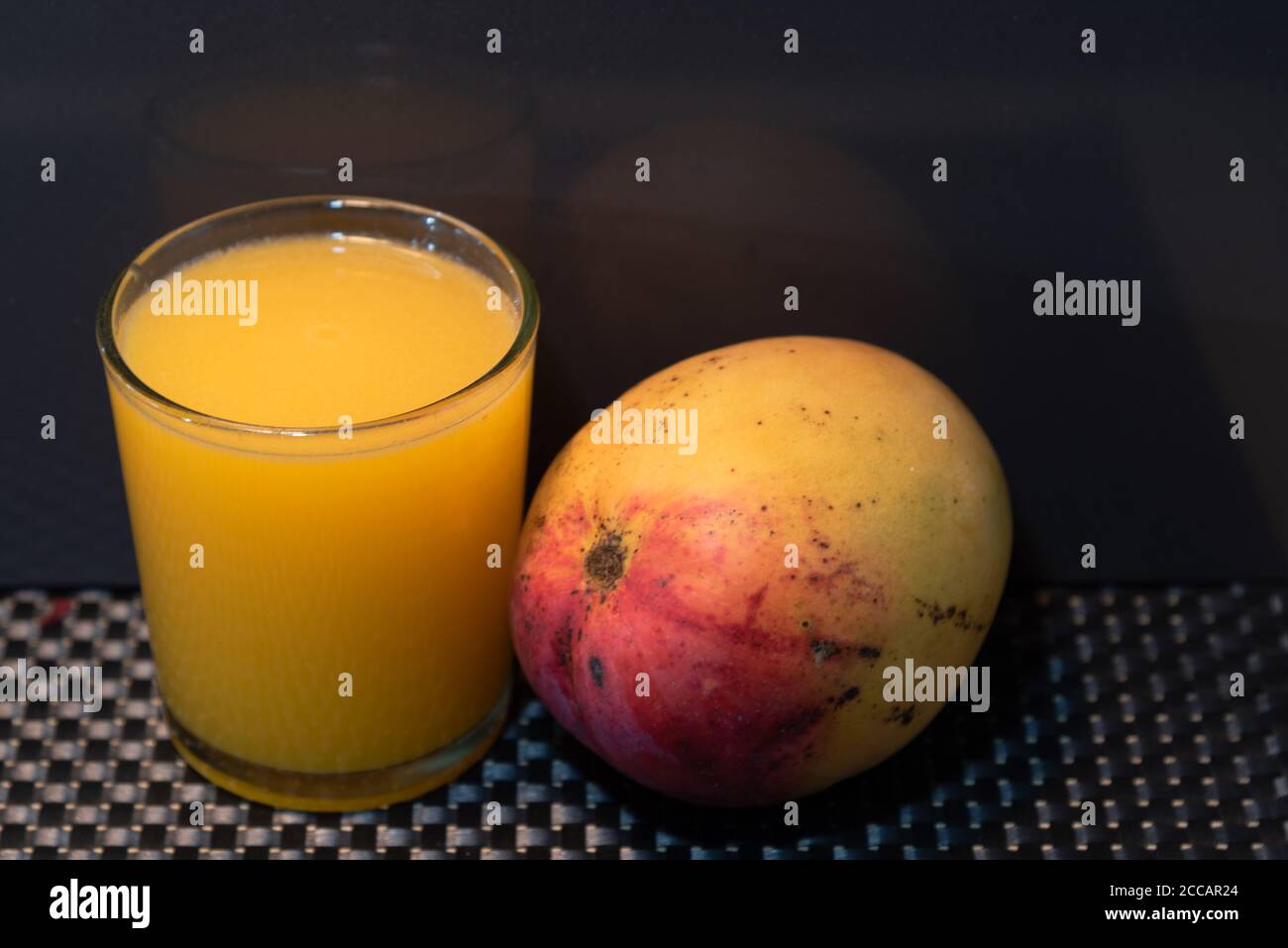 Mango juice (Mangifera indica). Tropical fruit. Fruit rich in fiber