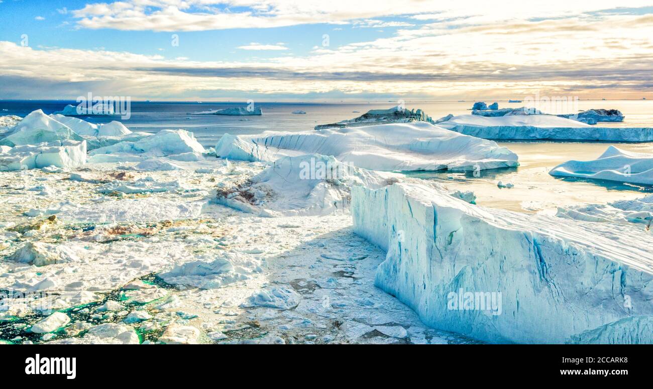 Global Warming and Climate Change - Icebergs from melting glacier in icefjord Stock Photo