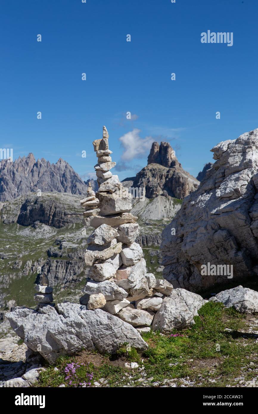 Cairns are principally used as points of reference, particularly in the mountains; they are built by hikers to mark the route in the absence of signs Stock Photo