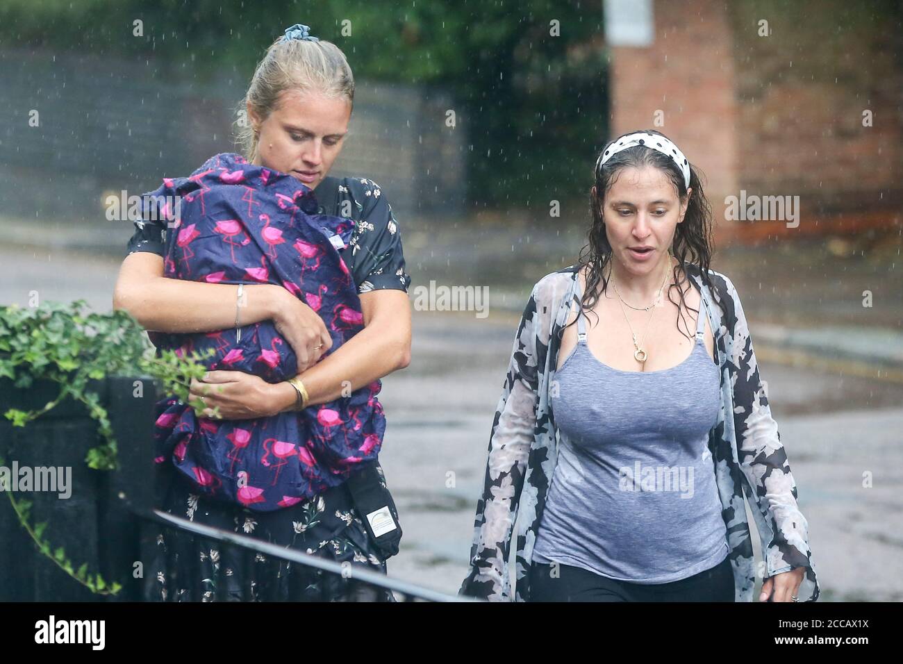 Women are caught in heavy rain as Storm Ellen brings rainfall with gusty winds in north London.According to the Met Office, warmer weather with highs of 24 degrees Celsius is forecasted for the rest of the week. Stock Photo