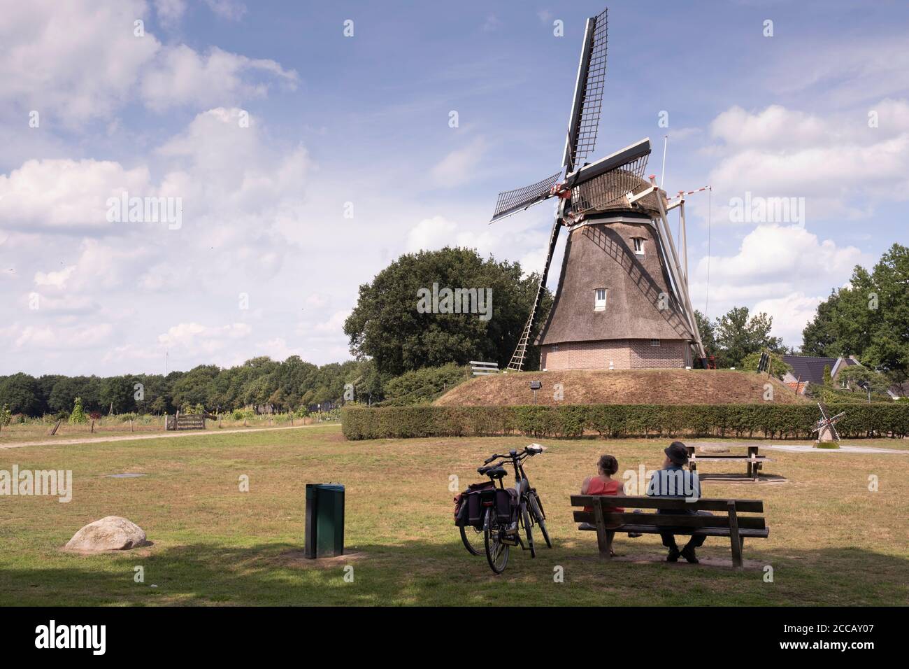 People Sit On A Bench In The Grass In Front Of The Jantina Hellingmolen A Dutch Windmill In Little Village lden In Drenthe Stock Photo Alamy