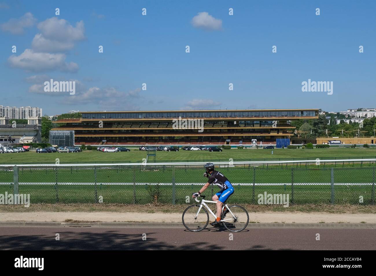 Cyclist riding past Longchamp racecourse in Paris, France, Europe. Stock Photo