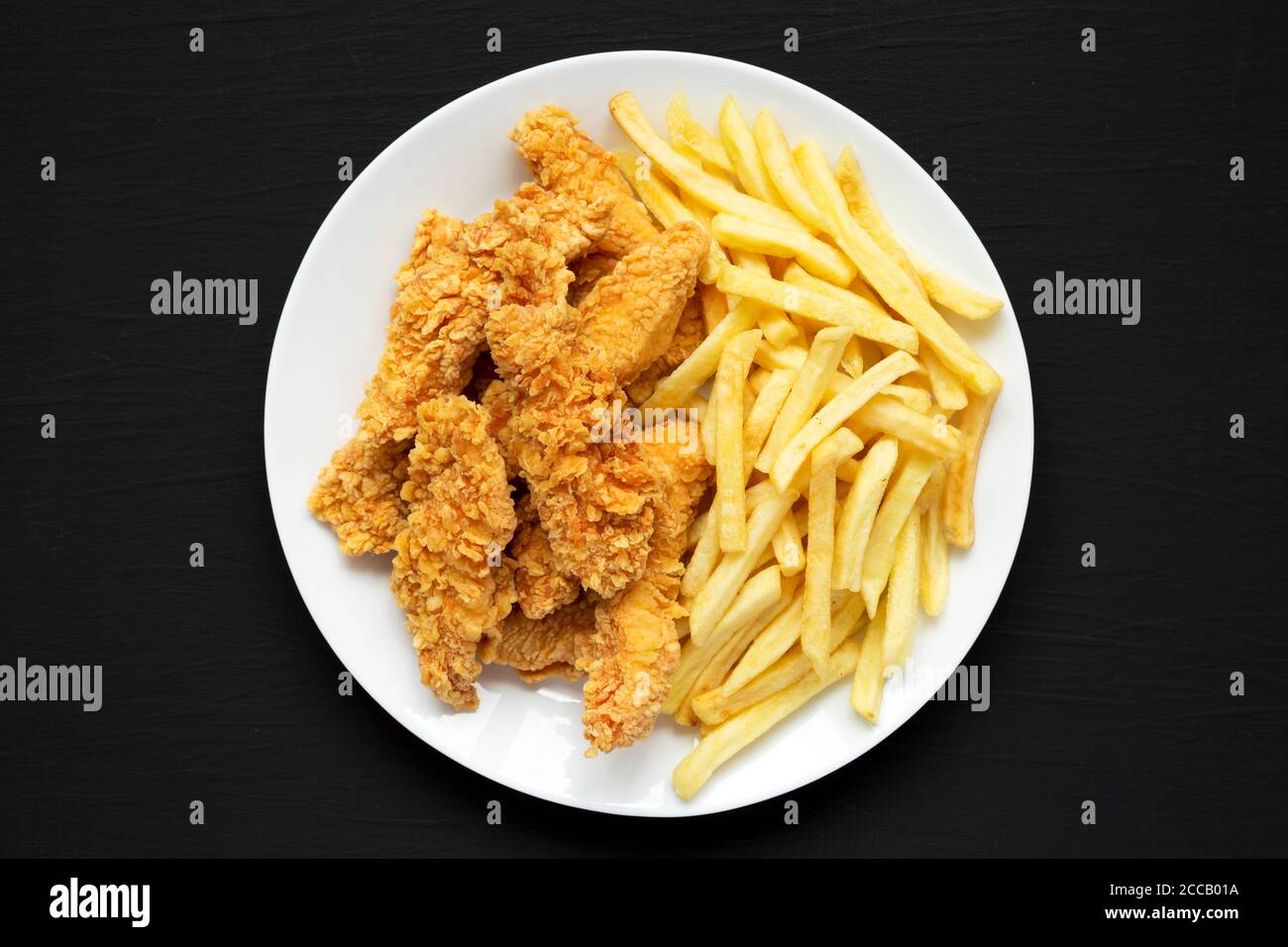 Homemade Crispy Chicken Tenders and French Fries on a white plate on a
