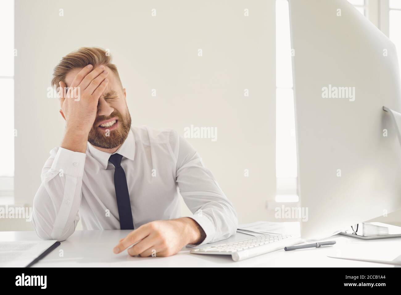 Unemployed businessman in gray office. Unemployment. Crisis. Stock Photo