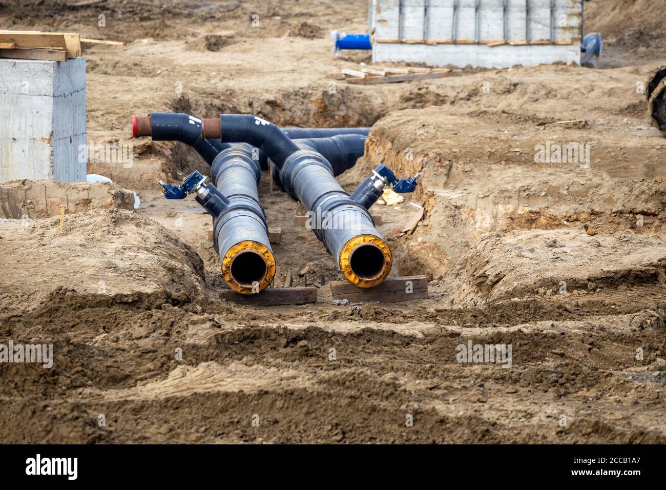 New black pipes laying in the ground, heat pipeline of residential