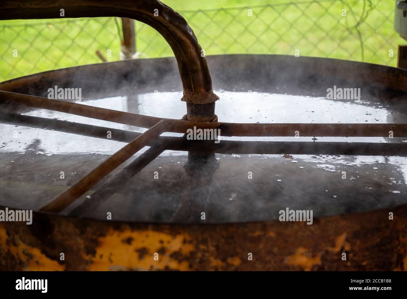 Part of distillation apparatus with cooler for making distillate. Homemade distillery making