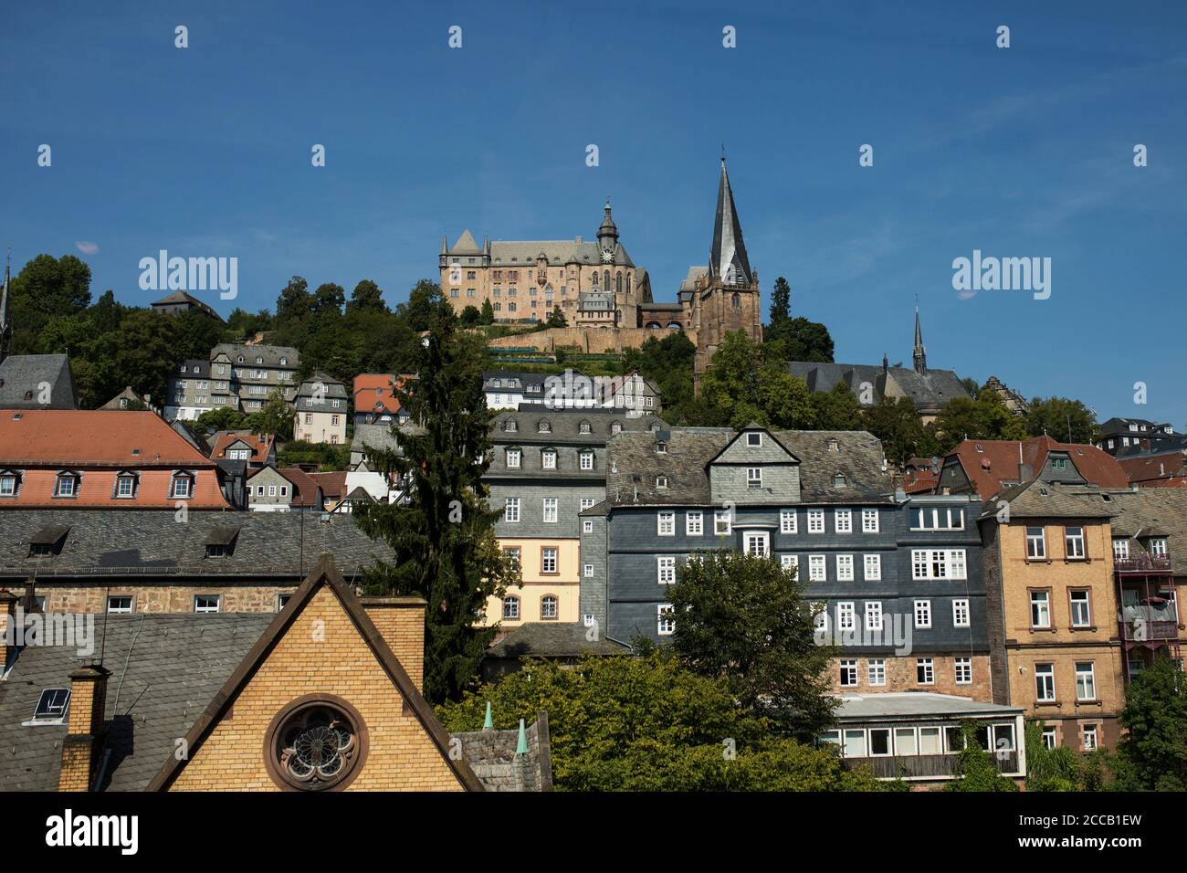 A view of the city of Marburg, Germany, with the Landgrafen Palace and St Mary's Lutheran church looking down from the hilltop. Stock Photo
