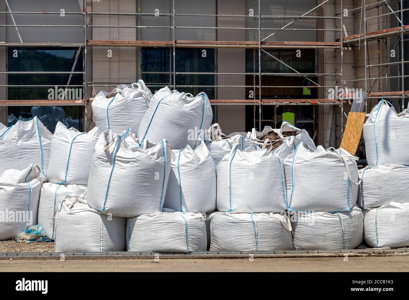 Sacks with construction waste on the street. Construction waste in builders plastic waste bag