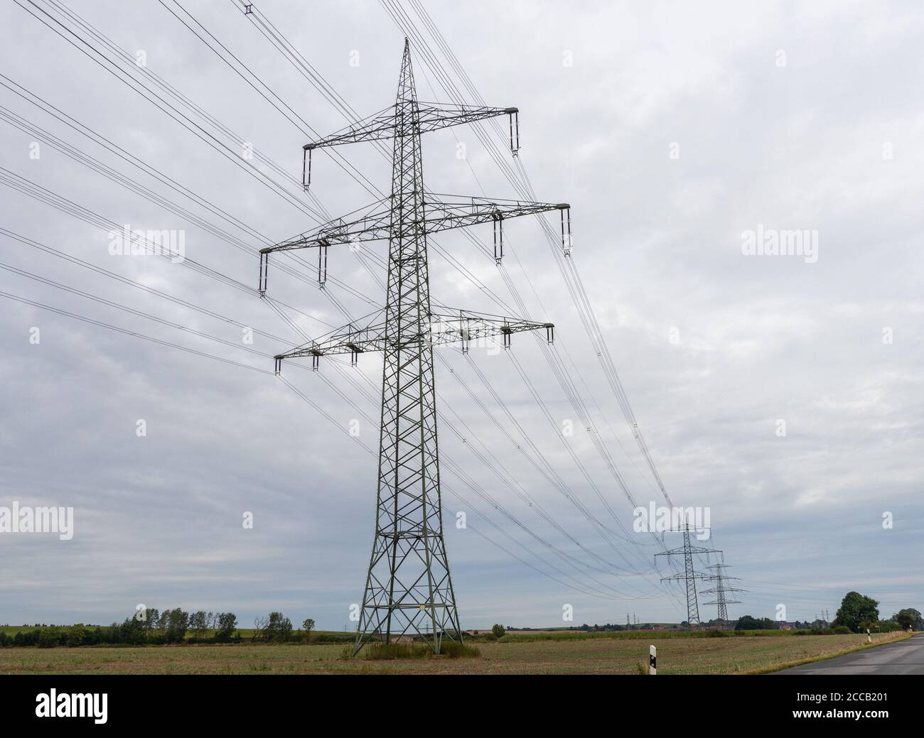 huge power poles run power lines across the country Stock Photo Alamy