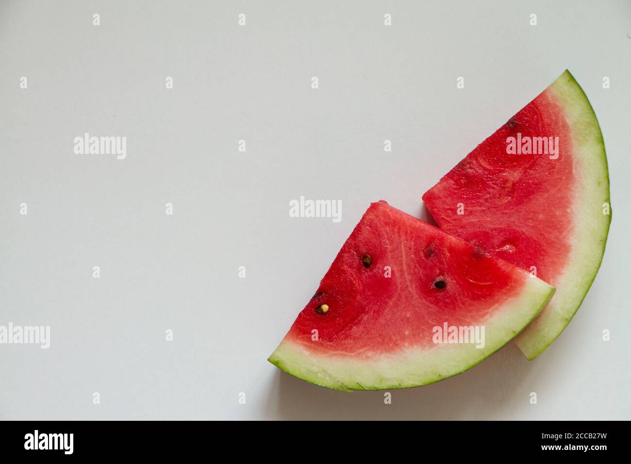 Two slices of ripe watermelon on white background, top view Stock Photo