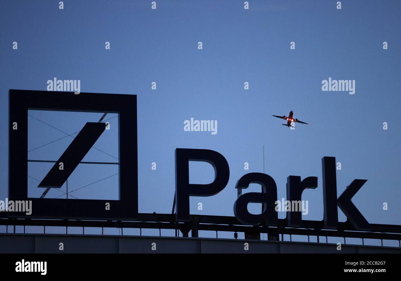 A plane flies over the new logo of the Deutsche Bank Park football stadium, named after Germany's largest business bank, before it is illuminated for the first time in Frankfurt, Germany, August 20, 2020. REUTERS/Kai Pfaffenbach Stock Photo
