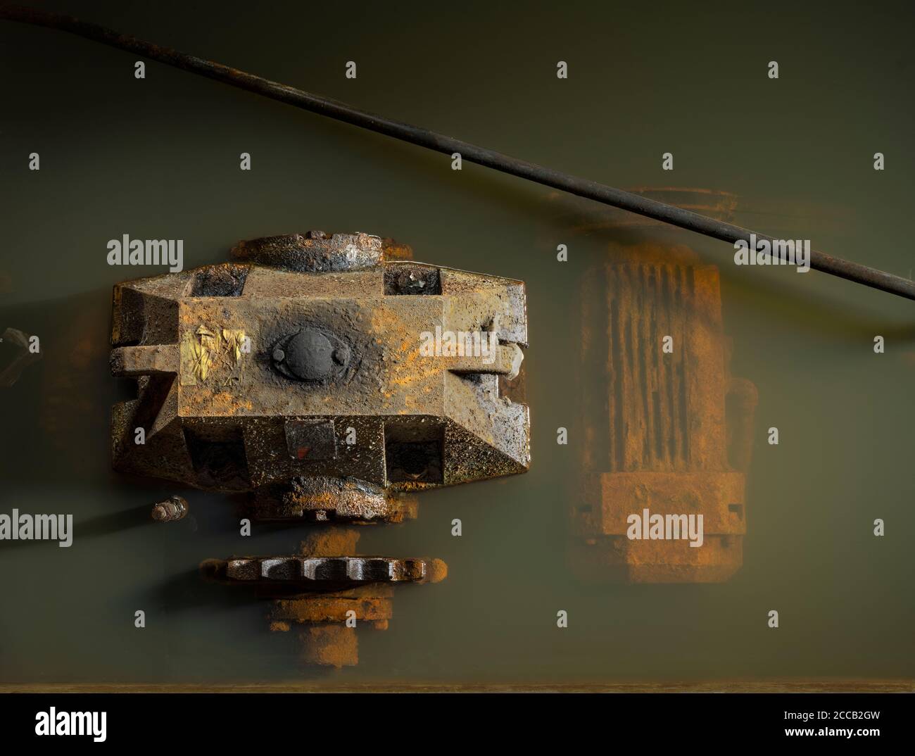 Rusty pump machinery underwater in abandoned factory. Stock Photo