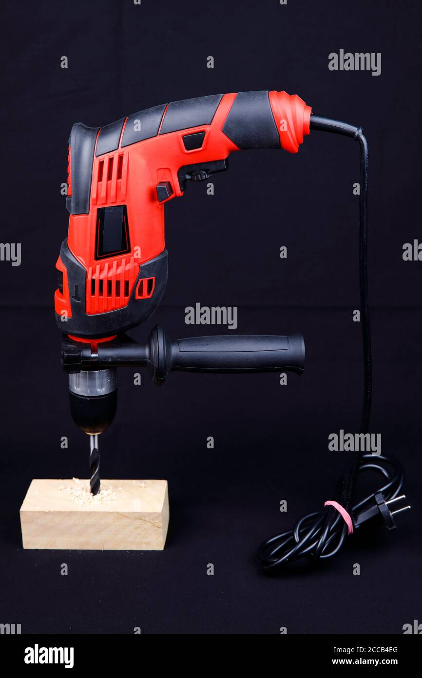 An electric drill isolated on black background Stock Photo