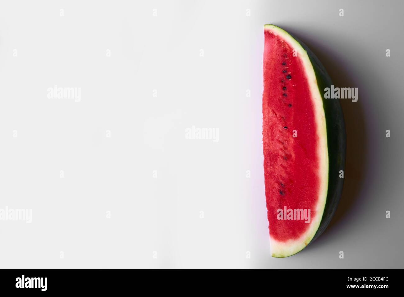 Watermelon slice on a white background, sweet summer foods Stock Photo