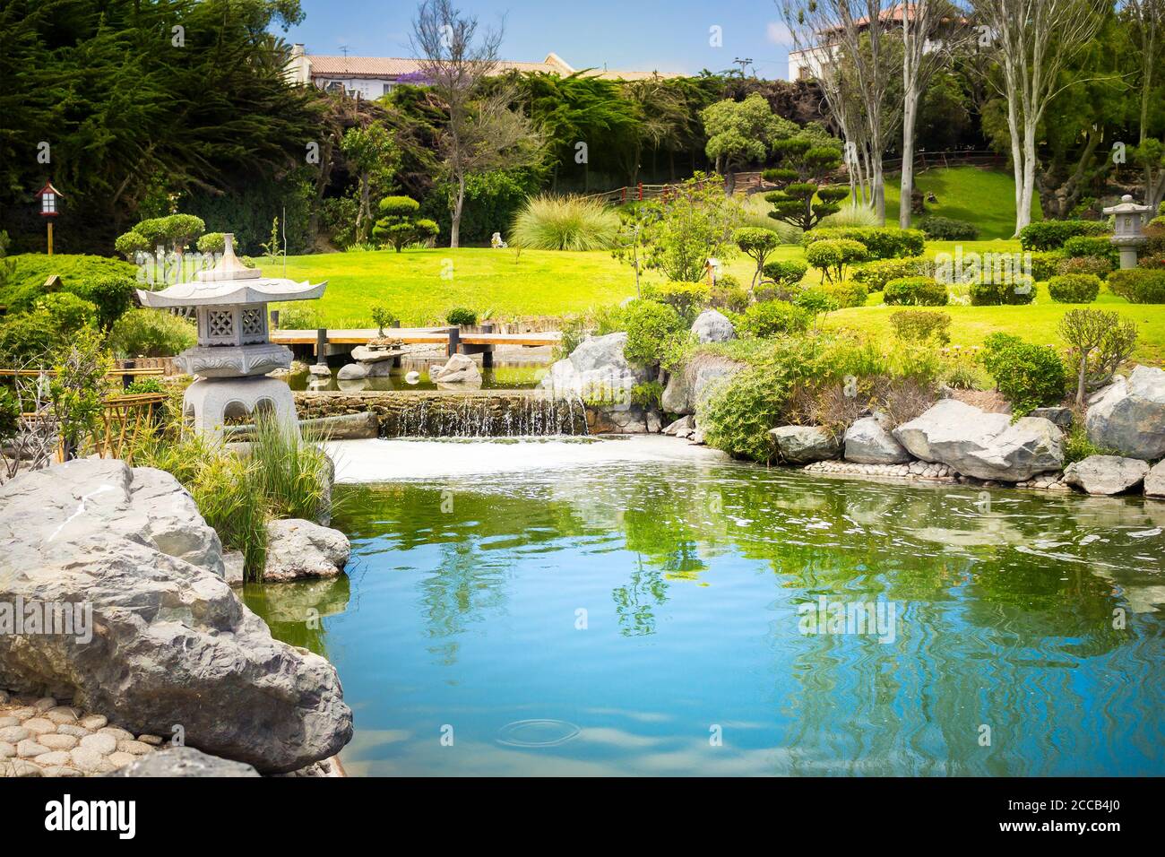 Japanese garden with stone lantern and reflections in the pond in La Serena, Chile Stock Photo