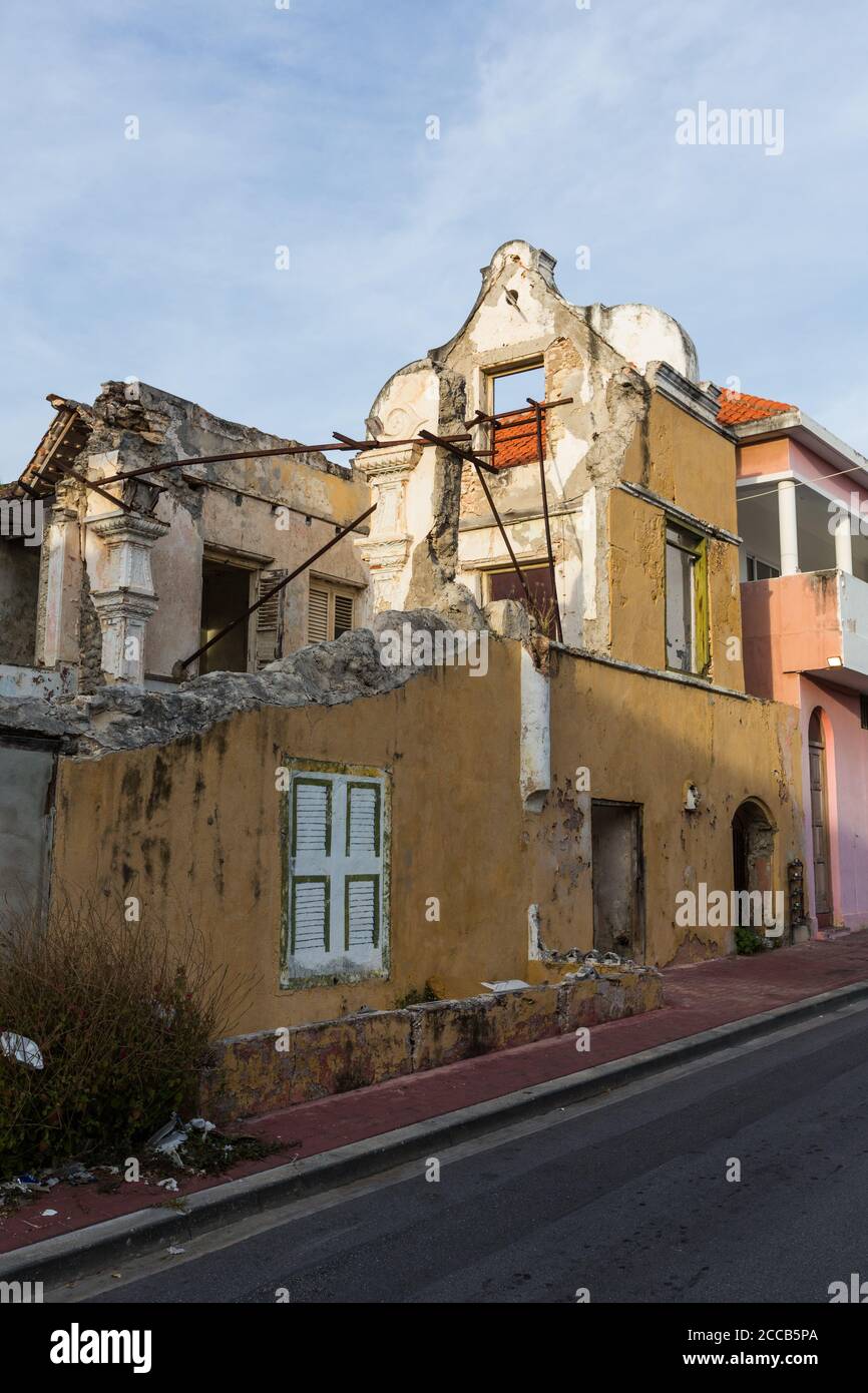 Colonial Dutch architecture with curved gables in a derelict historic building awaiting restoration in the Scharloo district of Willemstad.  The Histo Stock Photo