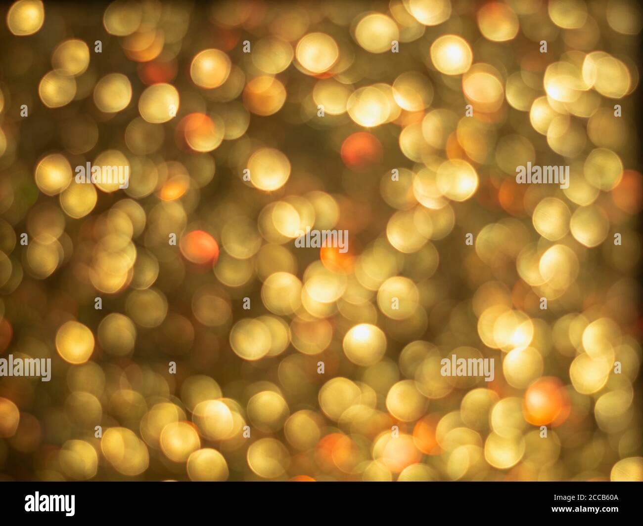 Gold bokeh holiday textured glitter background. Blurred abstract holiday background. Sparkling Glitter bokeh. Stock Photo
