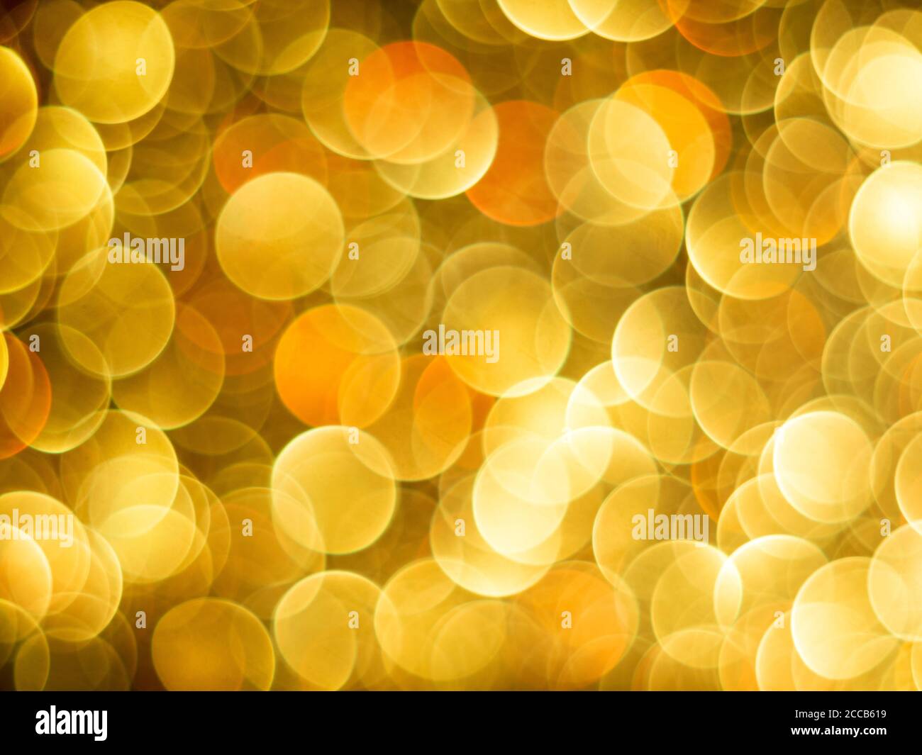 Gold bokeh holiday textured glitter background. Blurred abstract holiday background. Sparkling Glitter bokeh. Stock Photo
