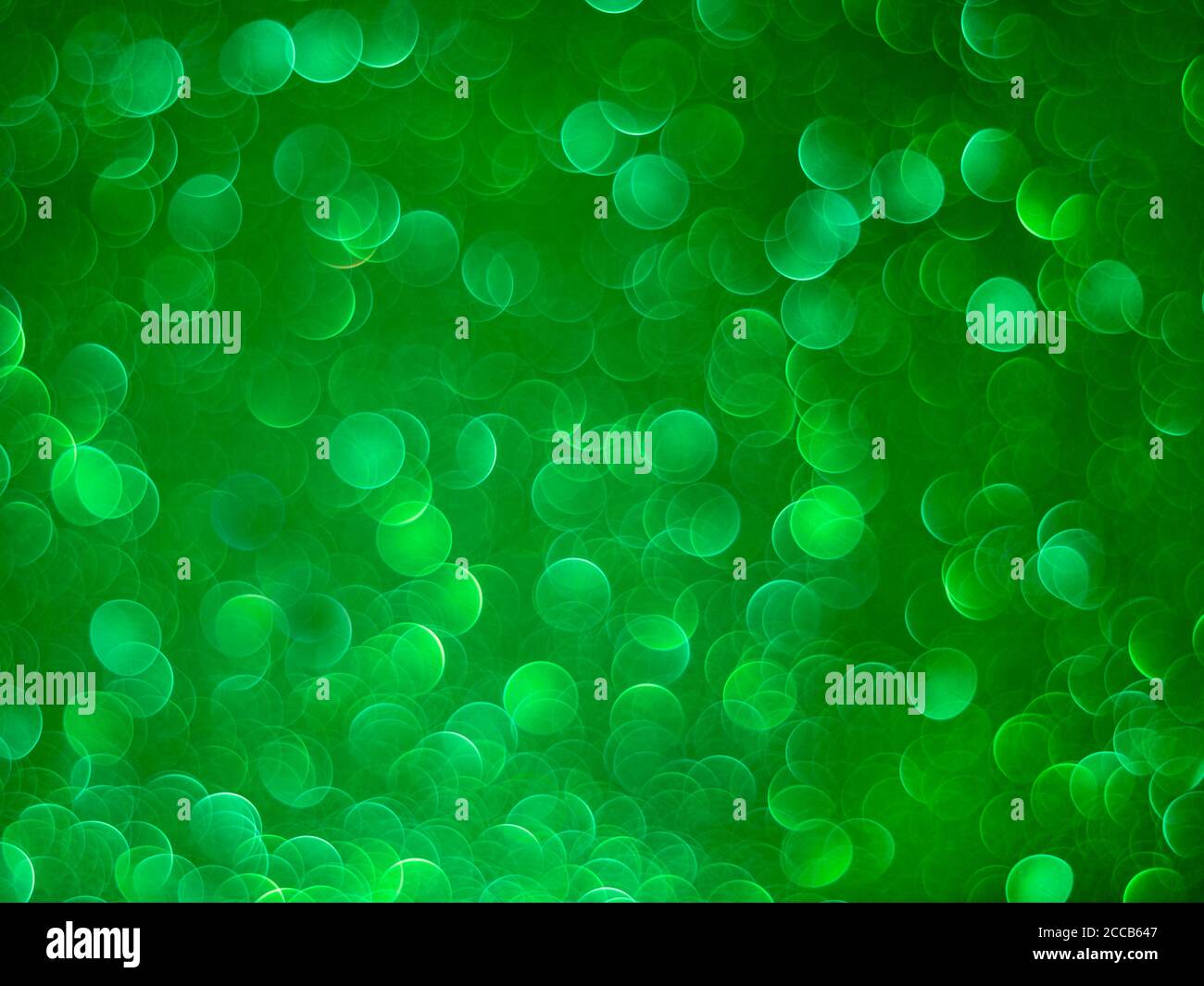 Green bokeh holiday textured glitter background. Blurred abstract holiday background. Sparkling Glitter bokeh. Banner Stock Photo