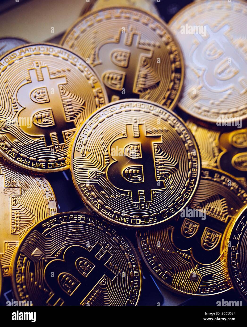 Bitcoin coins on laptop keyboard. Cryptocurrency background. Stock Photo